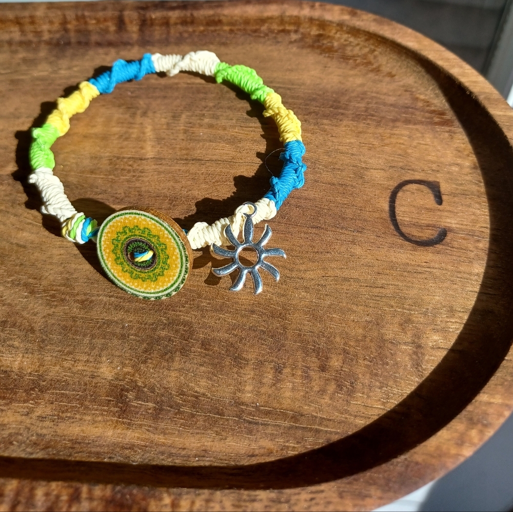 Brand new, handmade Brazilian waxed string bracelet with sun charm and button.